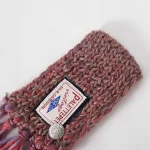 Elevate your pet's winter style with the Rust-Toned Handcrafted Knitted Pet Scarf. This beautifully woven scarf features a warm rust color with intricate textures and playful tassel detailing. The soft, high-quality yarn ensures a cozy feel while providing lightweight warmth, making it perfect for cold weather outings or indoor lounging. Finished with a charming logo patch and decorative button, this scarf adds a sophisticated touch to your pet's wardrobe. Pair it with a coat or wear it alone for a versatile and stylish look.