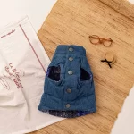 Keep your pet cozy and stylish with the Denim Button-Up Quilted Pet Vest. Made with a premium denim outer layer and a soft quilted design, this vest provides optimal warmth and comfort for cool autumn days and frosty winter walks. The elegant button-up closure ensures easy wear while adding a touch of sophistication to your pet's look. Perfect for layering or wearing on its own, this versatile vest is suitable for pets who love both functionality and fashion. Pair it with a bandana or leash for an effortlessly chic outfit.