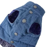 Combine functionality with style in the Quilted Denim Button-Up Pet Vest. Featuring a sleek denim outer layer and a cozy quilted interior, this vest ensures your pet stays warm during chilly weather while maintaining a fashionable look. The detailed flower-patterned snap buttons provide both security and elegance, while the tailored fit ensures ease of movement. Ideal for autumn walks, winter outings, or simply making a style statement. Pair this vest with other accessories to create a chic, coordinated look for your pet.